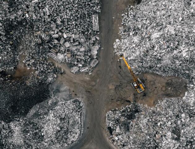 Aerial-view-of-metal-recycling-facility-with-backhoe-matthew-henry